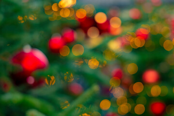 Christmas holidays festive illumination bokeh light green yellow red and orange vivid colors...