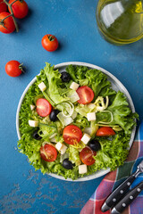 Lettuce, cheese, olives, onion and cherry tomatoes. Diet food concept.