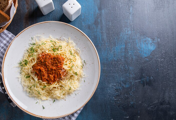 Spaghetti Bolognese on a plate. Top view, text space