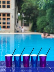 Fototapeta na wymiar Beach background with many cocktails cups near swimming pool,Albania