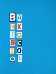 letters “back to school” cut from a magazine on a blue  background