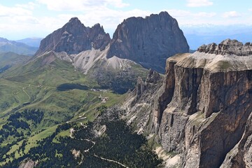 view from terrace of the dolomites to sella tower, langkofel mountain range and green valley