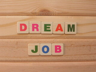 Word Dream Job on wood background