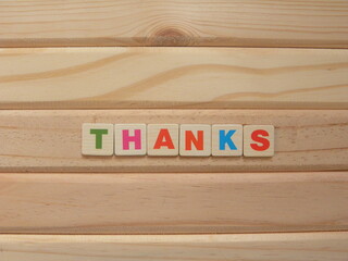 Word Thanks on wood background