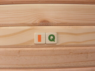 Abbreviation IQ (Intelligence Quotient) on wood background
