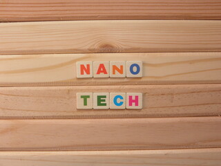 Word Nano Tech on wood background