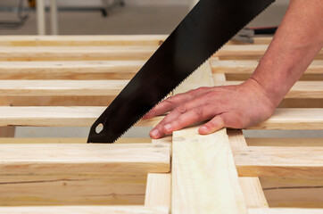 man makes a wooden bed with his own hands, hand made