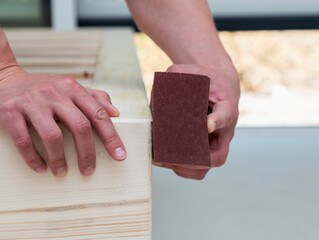 man makes a wooden bed with his own hands, hand made