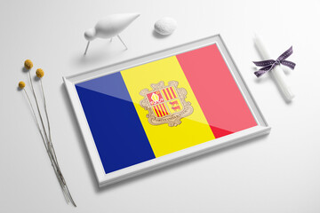 Andorra flag in wooden frame on table. White natural soft concept, national celebration theme.
