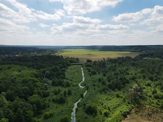Aerial view of rural summer landscape with fields and forest on a sunny day 