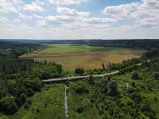 Aerial view of rural summer landscape with fields and forest on a sunny day 