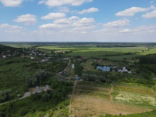 Aerial view of rural summer landscape with fields and forest on a sunny day 