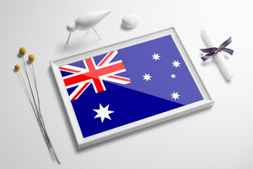 Australia flag in wooden frame on table. White natural soft concept, national celebration theme.