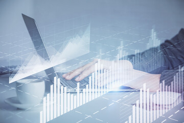 Double exposure of businesswoman hands typing on computer and forex graph hologram drawing. Financial analysis concept.