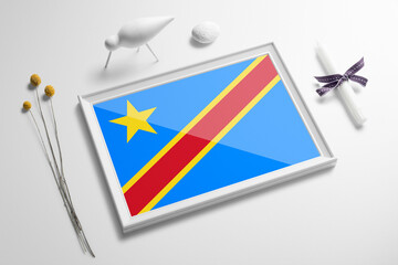 Congo flag in wooden frame on table. White natural soft concept, national celebration theme.