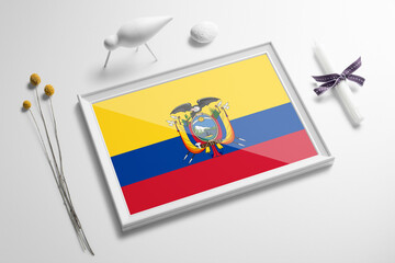 Ecuador flag in wooden frame on table. White natural soft concept, national celebration theme.