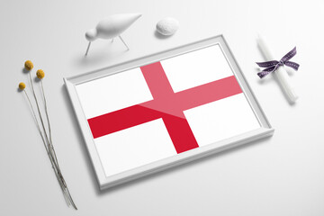England flag in wooden frame on table. White natural soft concept, national celebration theme.