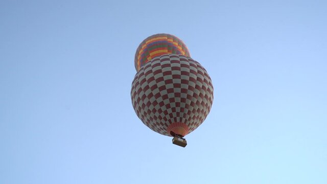 hot air balloons in Cappadocia. hot air balloon panning tracking shoot.  balloons at sunrise in Nevsehir Cappadocia. turkey tourism trip. visit turkey. cavusin avanos. Colorful hot air balloons.