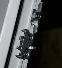 fasteners and connectors for installing and configuring plastic Windows during renovation by service centers close-up. Fuzziness.