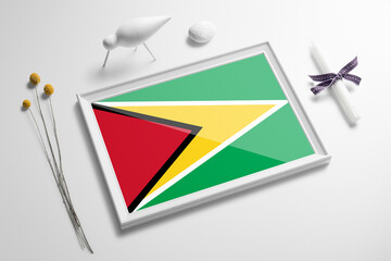 Guyana flag in wooden frame on table. White natural soft concept, national celebration theme.