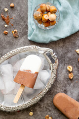Chocolate ice cream on a stick. On a black background. Top view.