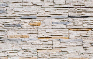 Decorative bricks in the interior in cream and gray colors, brickwork, wall design.