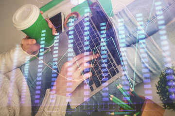 Double exposure of woman hands typing on computer and forex chart hologram drawing. Stock market invest concept.