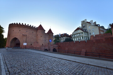 The Barbican Tower in the Warsaw Old Town in the light of the rising sun.