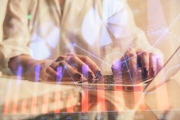 Double exposure of woman hands typing on computer and forex chart hologram drawing. Stock market invest concept.