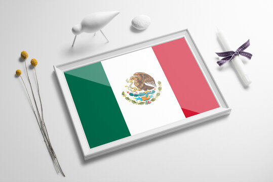 Mexico flag in wooden frame on table. White natural soft concept, national celebration theme.