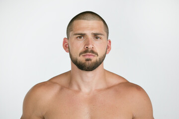 Portrait of a man looking at the camera is brutal, short hairstyle and beard.