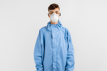 male doctor dressed in a protective suit against coronavirus, wearing a medical mask, glasses and gloves, on an isolated white background. Quarantine, coronavirus