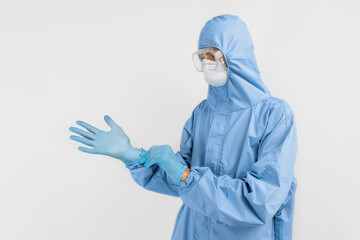 male doctor wears a protective suit to fight the covid-2019 coronavirus pandemic. Protective suit, safety glasses, gloves, respirator, on an white background