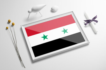 Syria flag in wooden frame on table. White natural soft concept, national celebration theme.