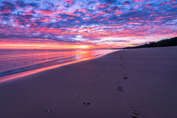 Foot prints along sunrise beach