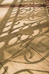 Tiled floor in a shallow focus with shadows. Abstract background with a space for your text.