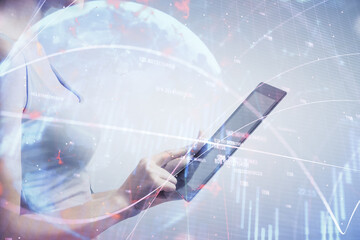 Double exposure of forex chart sketch hologram and woman holding and using a mobile device. Stock market concept.
