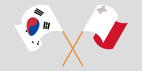 Crossed and waving flags of Malta and South Korea