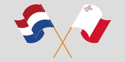 Crossed and waving flags of Malta and the Netherlands