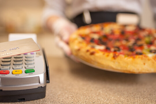 Bank terminal payment by wireless card for pizza services, takeaway food