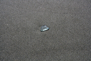 Dangerous splinter of glass on the sand on the beach, Limassol, Cyprus