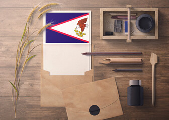 American Samoa invitation, celebration letter concept. Flag with craft paper and envelope. Retro theme with divide, ink, wooden pen objects.