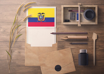 Ecuador invitation, celebration letter concept. Flag with craft paper and envelope. Retro theme with divide, ink, wooden pen objects.