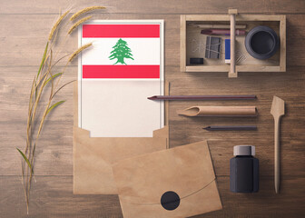 Lebanon invitation, celebration letter concept. Flag with craft paper and envelope. Retro theme with divide, ink, wooden pen objects.