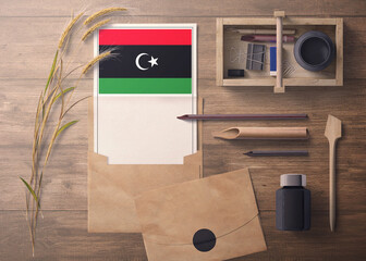 Libya invitation, celebration letter concept. Flag with craft paper and envelope. Retro theme with...