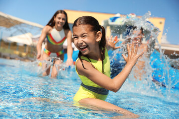 Happy family having fun at water park. Summer vacation