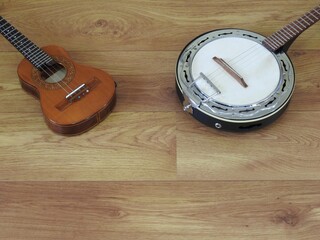 Close-up of two Brazilian string musical instruments: cavaquinho and samba banjo on a wooden...