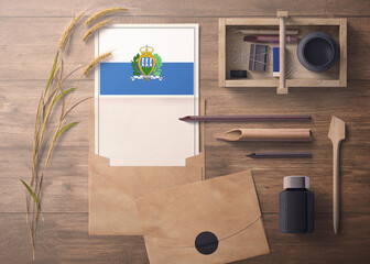 San Marino invitation, celebration letter concept. Flag with craft paper and envelope. Retro theme with divide, ink, wooden pen objects.