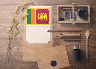 Sri Lanka invitation, celebration letter concept. Flag with craft paper and envelope. Retro theme with divide, ink, wooden pen objects.