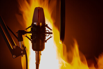 Studio professional microphone on the background of fire, effective photo